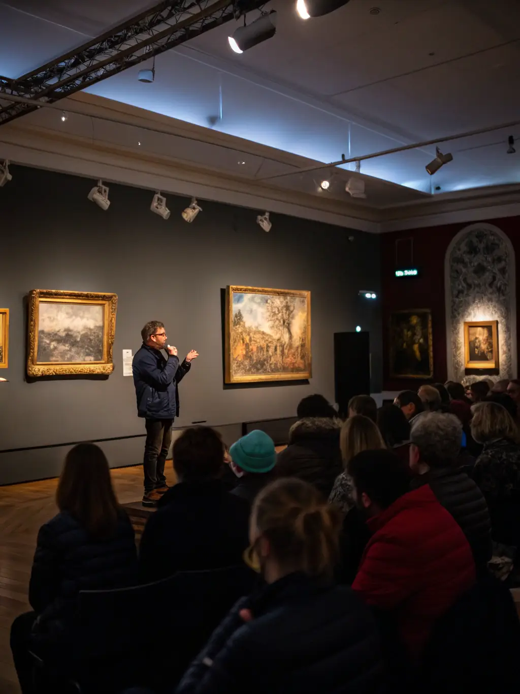 A photograph of a diverse group of adults attending a lecture on art history at the Musée d'Angoulême, highlighting the museum's educational initiatives.